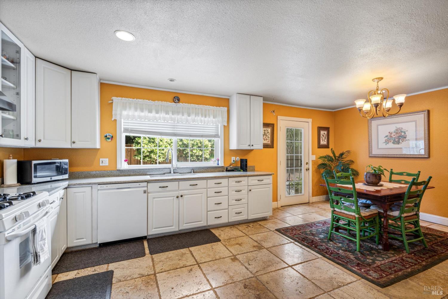 971 Eleanor Avenue Rohnert Park, CA 94928 - Photo 11 of 25 a kitchen with granite countertop cabinets a dining table and chairs