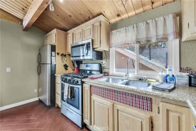 a kitchen with stainless steel appliances a refrigerator sink and white cabinets
