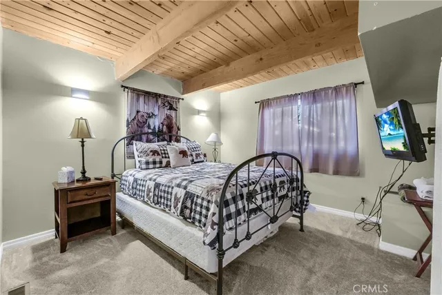 a bed sitting in a room next to a lamp