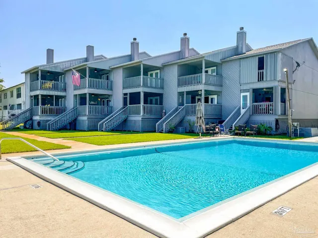 a view of a backyard with swimming pool