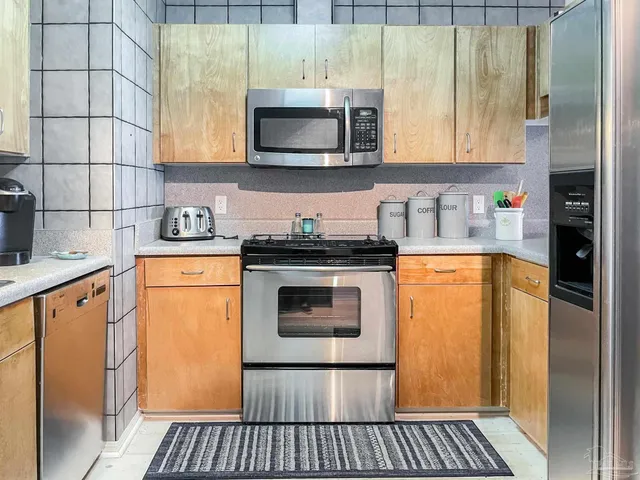 a kitchen with a sink a stove and cabinets