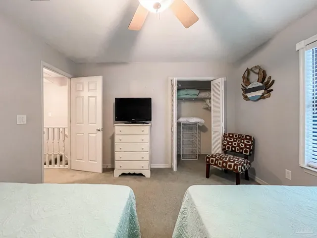 a bedroom with a bed and a television