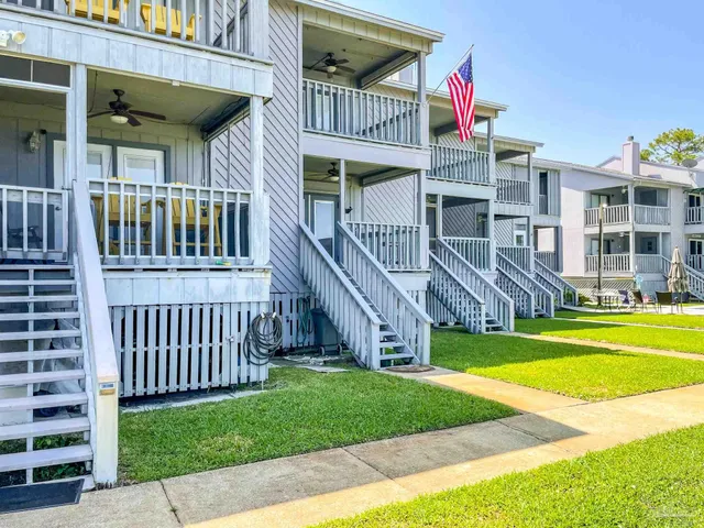 a view of a house with a yard and a deck