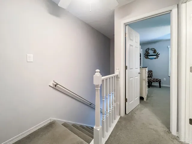 a view of a hallway with a livingroom and a hallway