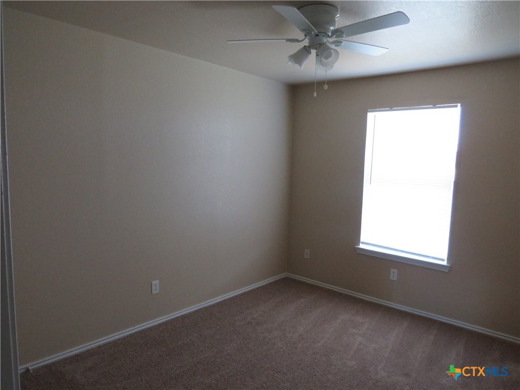 1602 Benttree Drive, Unit B Killeen, TX 76543 - Photo 13 of 15 an empty room with a window and a fan