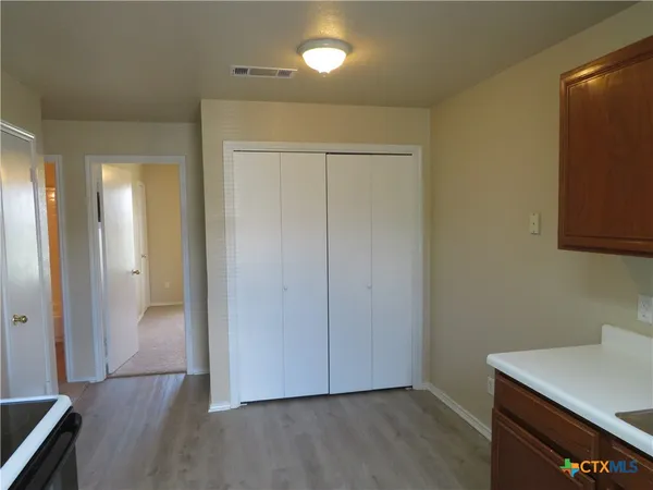 a view of a room with wooden floor