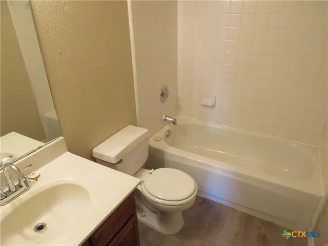 a white toilet sitting next to a bath tub