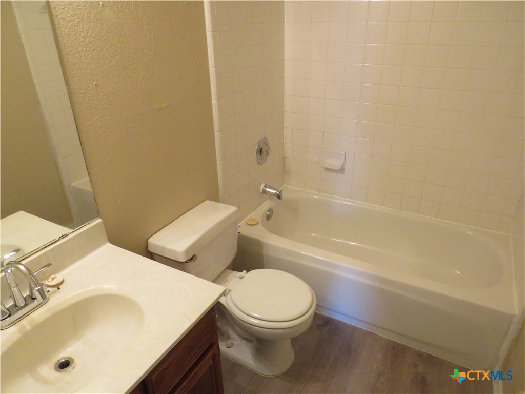 1602 Benttree Drive, Unit B Killeen, TX 76543 - Photo 10 of 15 a white toilet sitting next to a bath tub