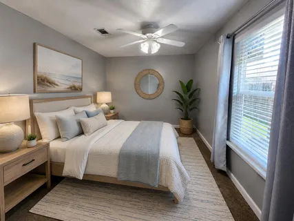 a bedroom with a large bed and a chandelier