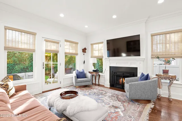 a living room with furniture a fireplace and a flat screen tv