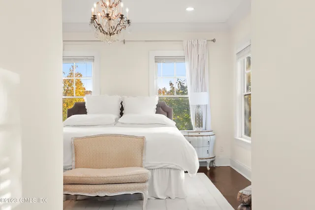 a bedroom with a bed and a chandelier