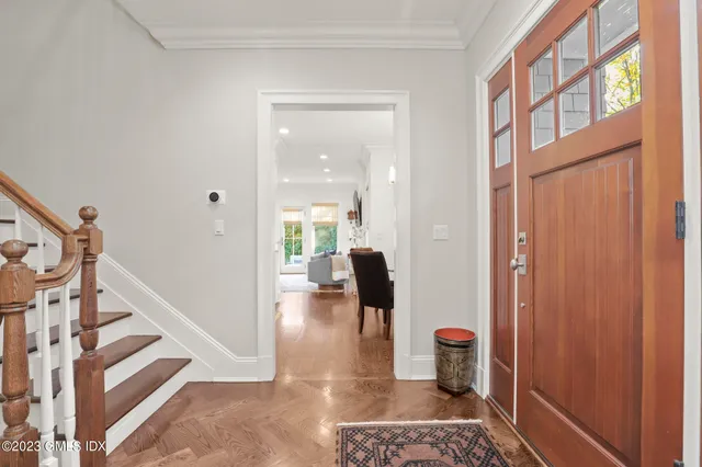 a view of hallway with wooden floor and stairs