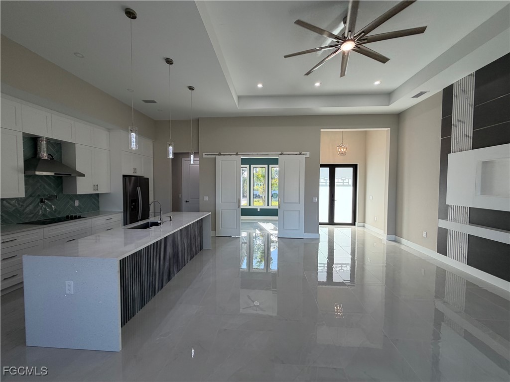 7968 3rd Terrace Lehigh Acres, FL 33936 - Photo 13 of 18 a large kitchen with kitchen island a sink a counter space and stainless steel appliances
