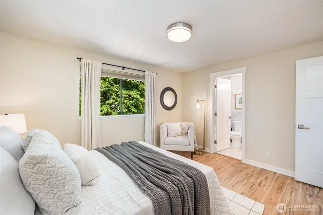 a bedroom with a large bed and a window