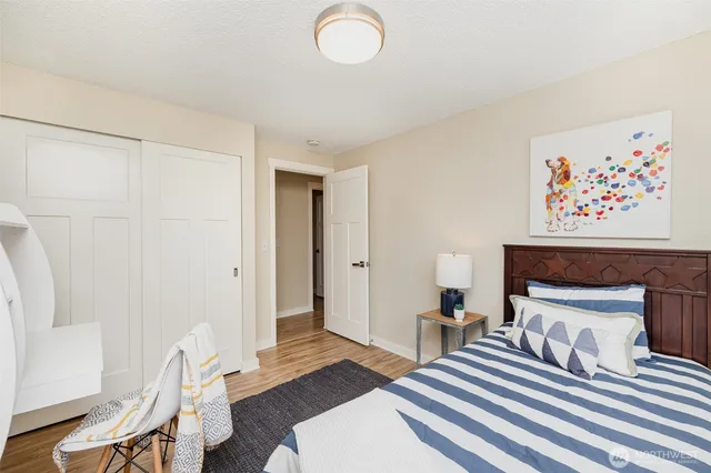 a bedroom with furniture and wooden floor