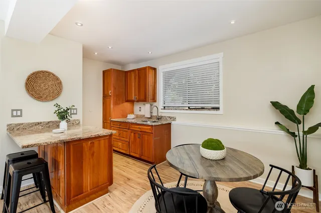 a kitchen with a table chairs and sink
