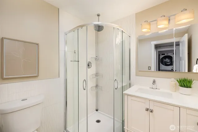 a bathroom with a shower sink and mirror