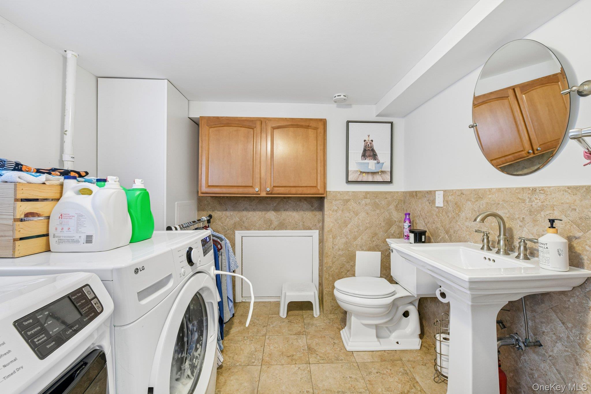 2821 Colonial Avenue Merrick, NY 11566 - Photo 25 of 29 a bathroom with a sink mirror and toilet