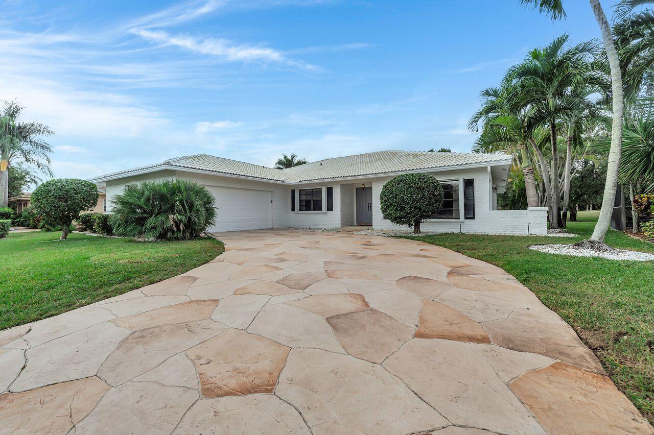 19699 Boca Greens Drive Boca Raton, FL 33498 - Photo 1 of 43 a front view of house with yard and green space