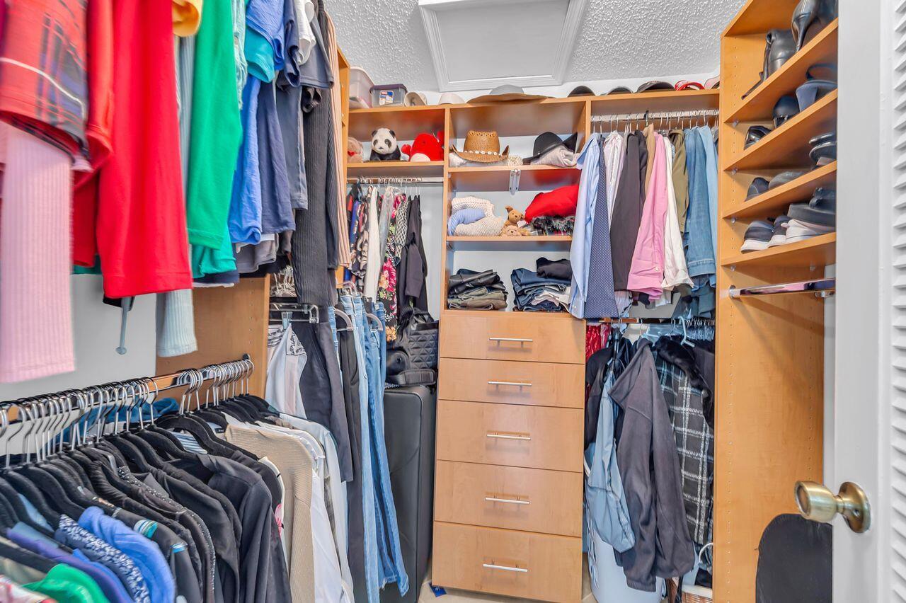 19699 Boca Greens Drive Boca Raton, FL 33498 - Photo 16 of 43 a view of walk in closet with clothes and shoes