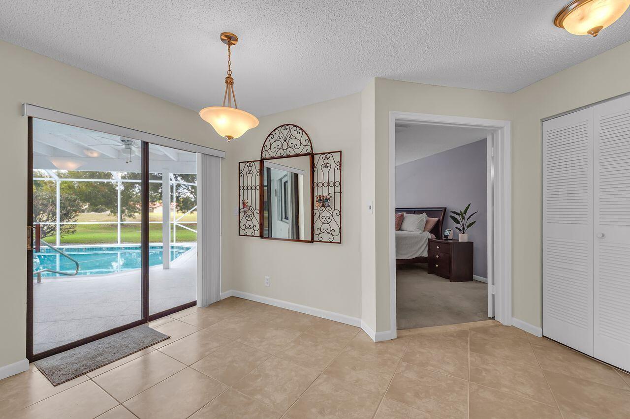 19699 Boca Greens Drive Boca Raton, FL 33498 - Photo 17 of 43 a view of a hallway to a livingroom with furniture