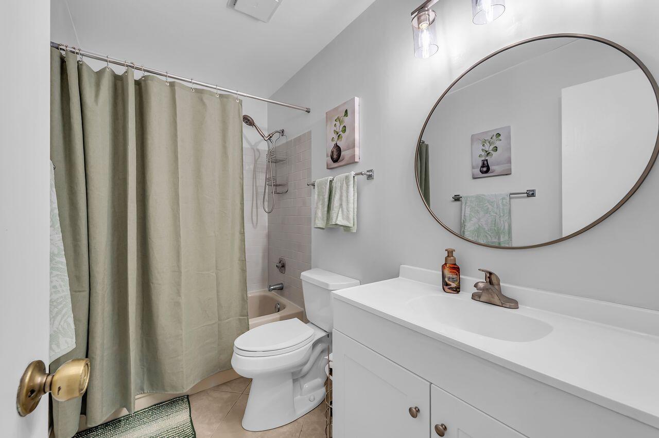 19699 Boca Greens Drive Boca Raton, FL 33498 - Photo 23 of 43 a bathroom with a sink a toilet and a mirror