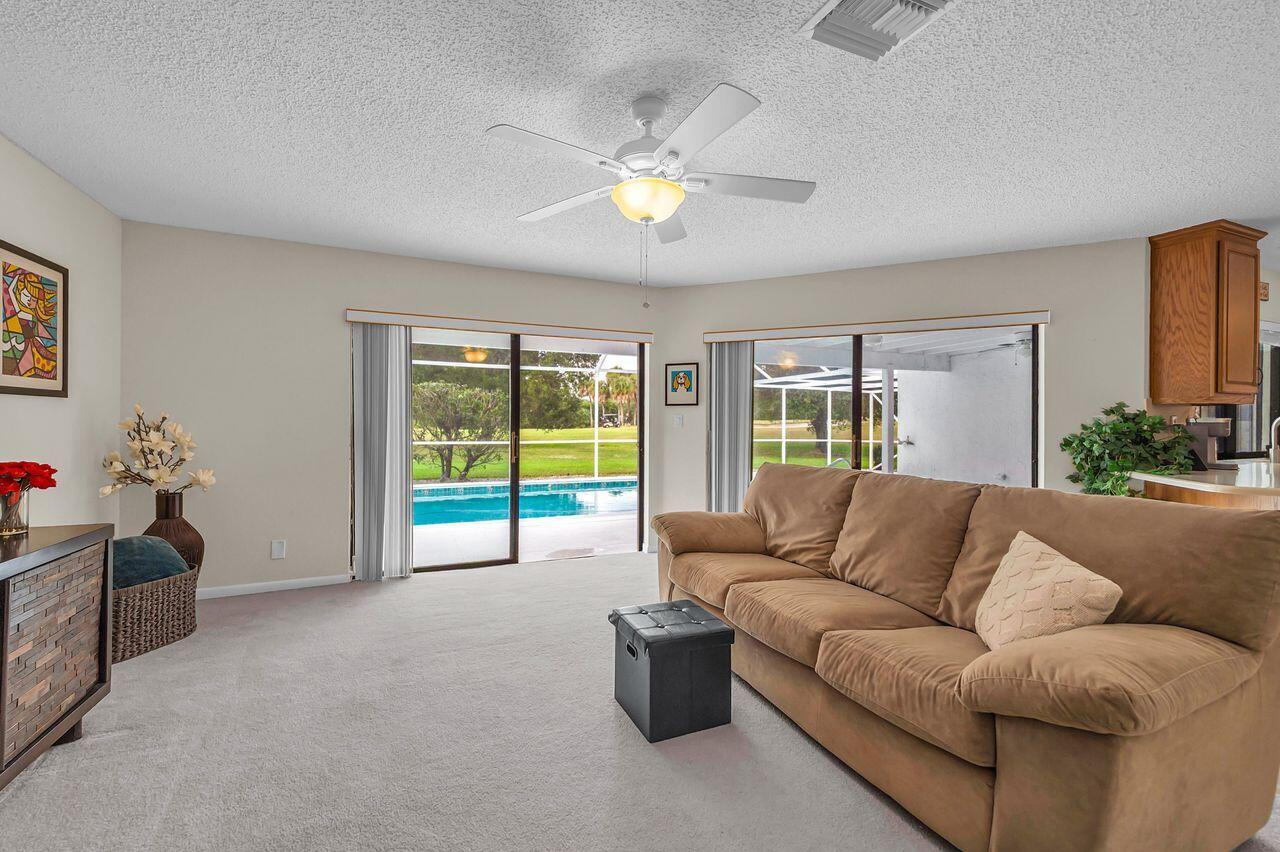 19699 Boca Greens Drive Boca Raton, FL 33498 - Photo 24 of 43 a living room with furniture and a chandelier