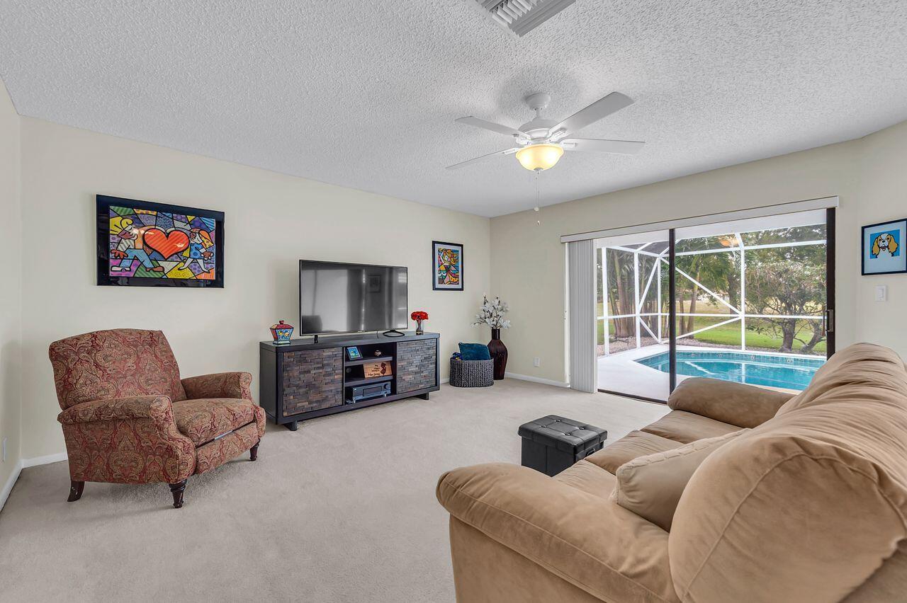 19699 Boca Greens Drive Boca Raton, FL 33498 - Photo 25 of 43 a living room with furniture and a flat screen tv