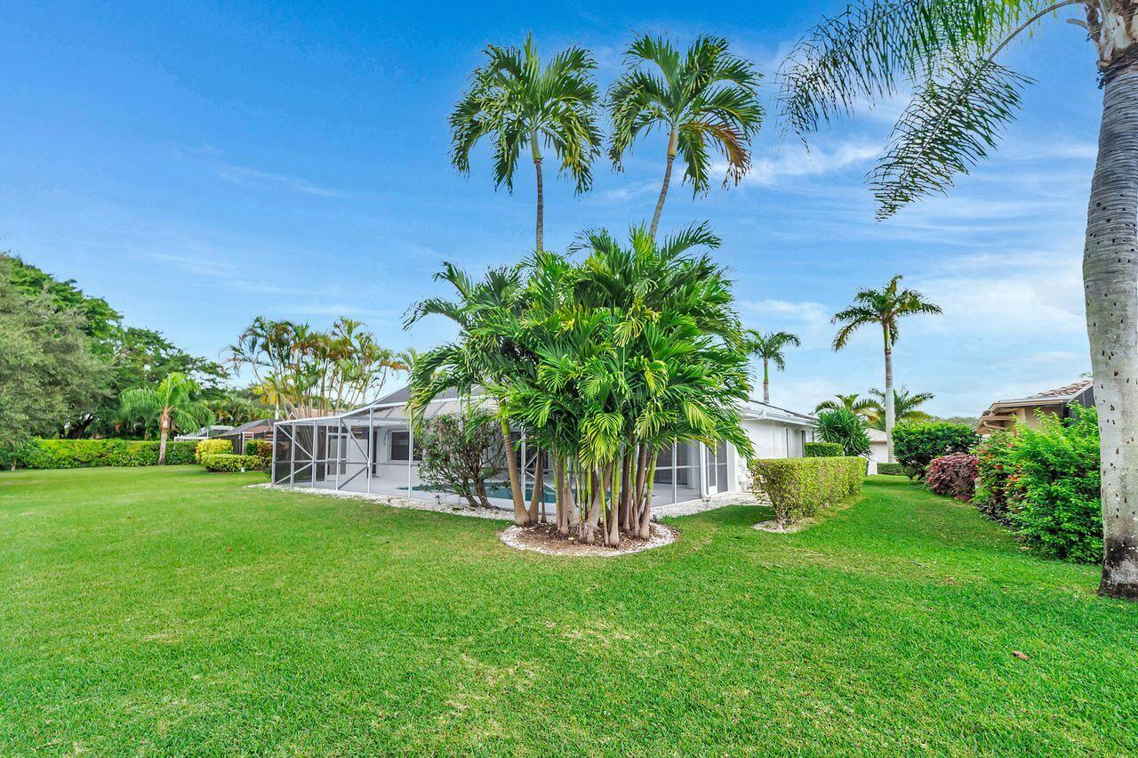 19699 Boca Greens Drive Boca Raton, FL 33498 - Photo 26 of 43 a view of a garden with a house in the background