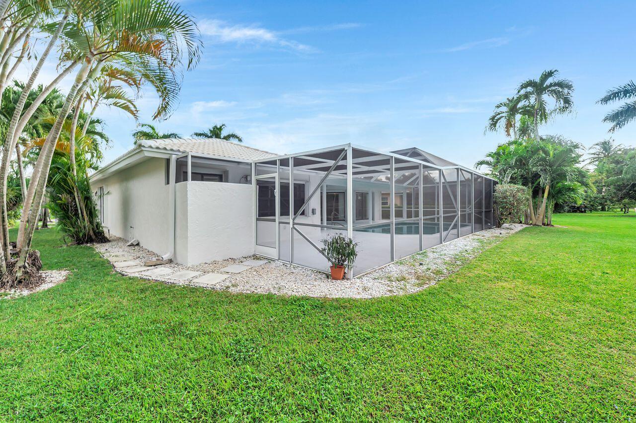 19699 Boca Greens Drive Boca Raton, FL 33498 - Photo 27 of 43 a view of a house with a yard and sitting area