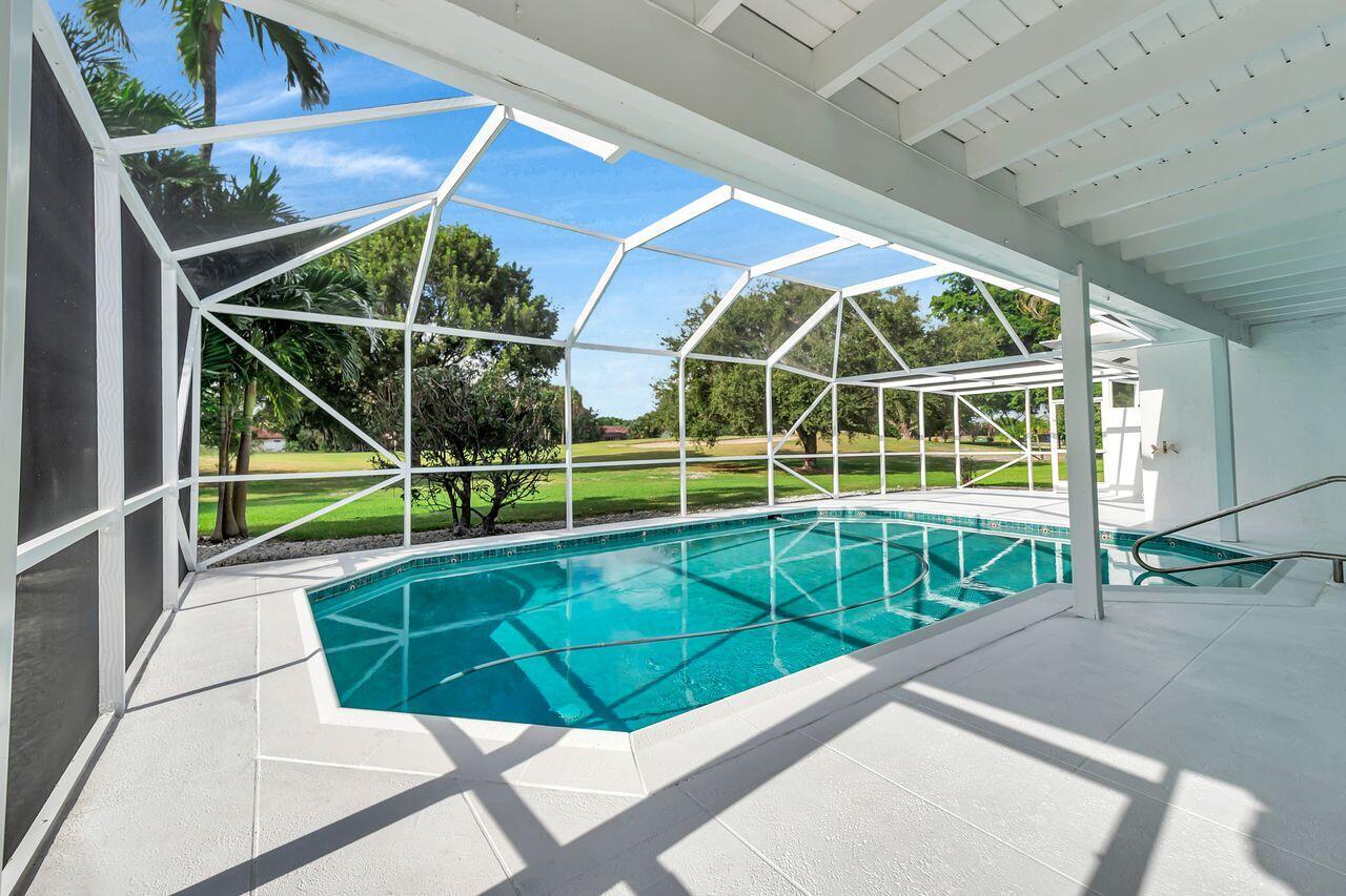 19699 Boca Greens Drive Boca Raton, FL 33498 - Photo 29 of 43 a view of a house with a swimming pool