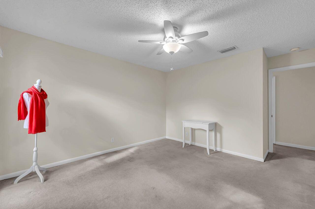 19699 Boca Greens Drive Boca Raton, FL 33498 - Photo 31 of 43 a view of a room with gym equipment and chandelier