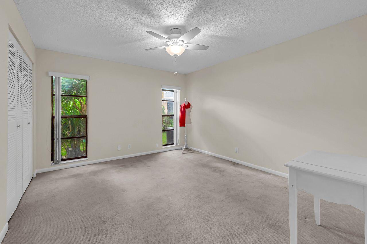 19699 Boca Greens Drive Boca Raton, FL 33498 - Photo 32 of 43 a view of a livingroom with a ceiling fan and window