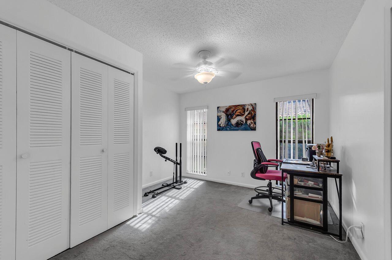 19699 Boca Greens Drive Boca Raton, FL 33498 - Photo 35 of 43 a living room with furniture and a window