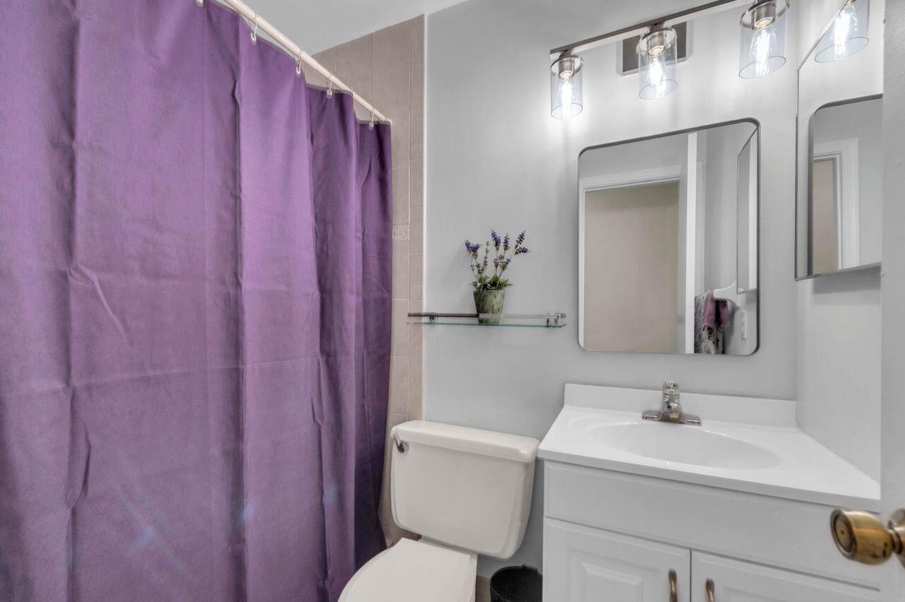 19699 Boca Greens Drive Boca Raton, FL 33498 - Photo 36 of 43 a bathroom with a sink a toilet and a mirror