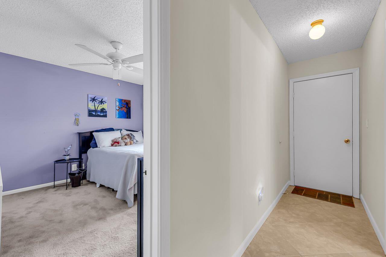 19699 Boca Greens Drive Boca Raton, FL 33498 - Photo 40 of 43 a room that has a bed and a dresser in it