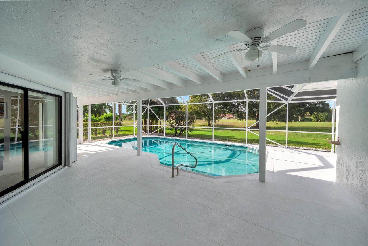 19699 Boca Greens Drive Boca Raton, FL 33498 - Photo 4 of 43 a view of a swimming pool with a yard and seating space