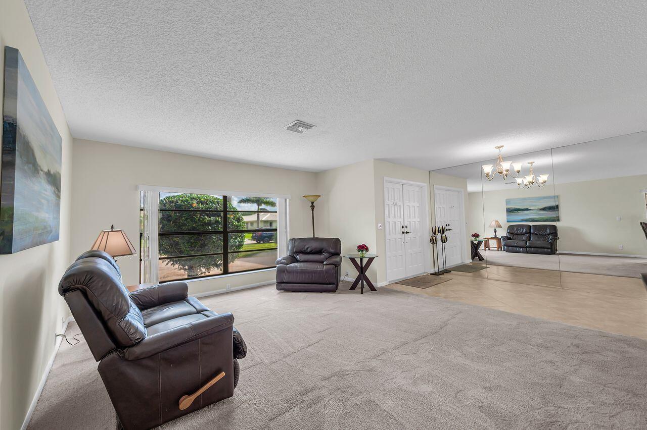 19699 Boca Greens Drive Boca Raton, FL 33498 - Photo 7 of 43 a living room with furniture and a large window