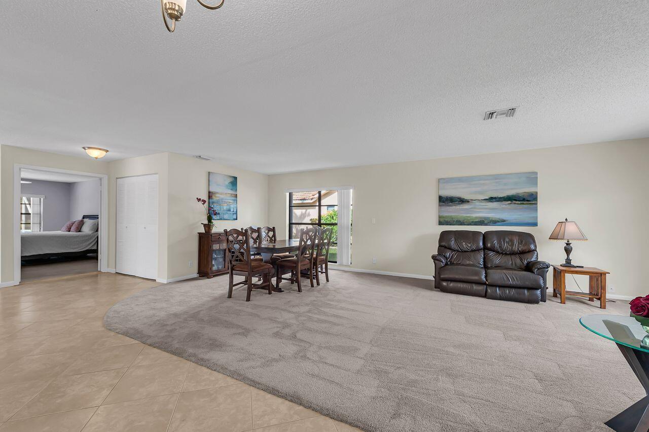 19699 Boca Greens Drive Boca Raton, FL 33498 - Photo 8 of 43 a living room with furniture and a table
