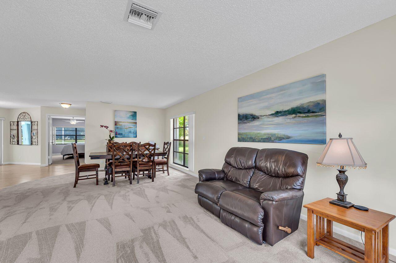 19699 Boca Greens Drive Boca Raton, FL 33498 - Photo 9 of 43 a living room with furniture and a lamp