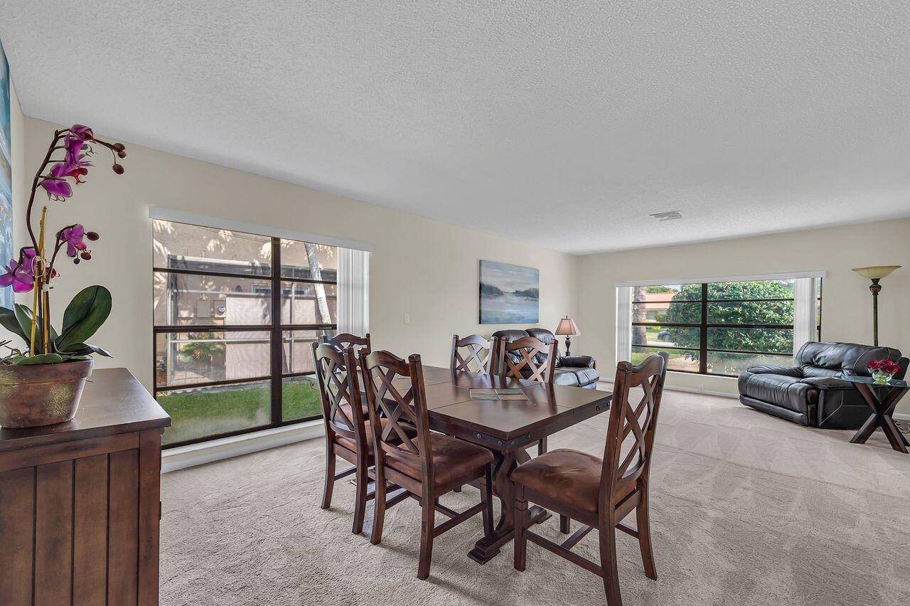19699 Boca Greens Drive Boca Raton, FL 33498 - Photo 10 of 43 a view of a dining room with furniture and window