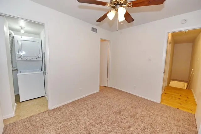 a view of an empty room with a fan