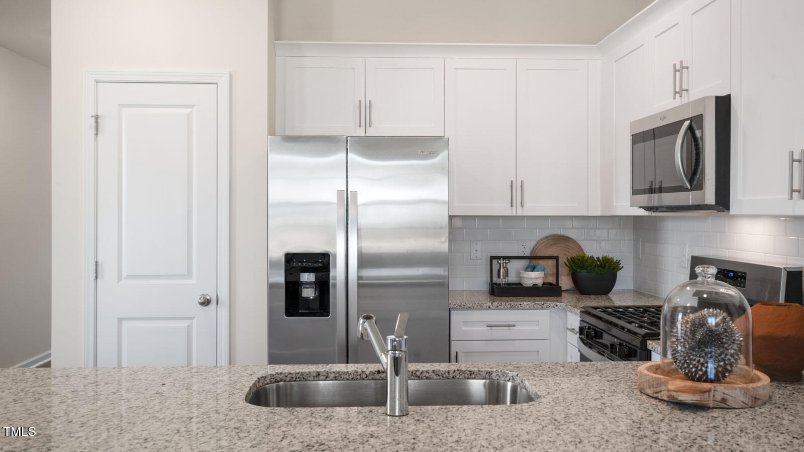 5233 Red Crimson Drive Willow Spring, NC 27592 - Photo 7 of 35 a kitchen with stainless steel appliances granite countertop a sink a refrigerator and a granite counter tops
