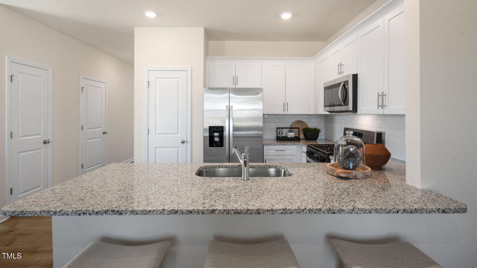 5233 Red Crimson Drive Willow Spring, NC 27592 - Photo 10 of 35 a kitchen with stainless steel appliances granite countertop a sink refrigerator and microwave