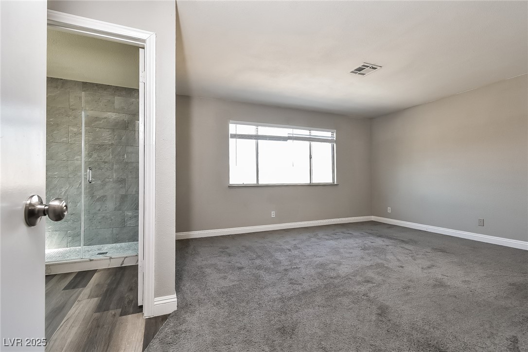 741 Round Table Drive Las Vegas, NV 89110 - Photo 10 of 22 Carpeted spare room featuring baseboards and wood finished floors
