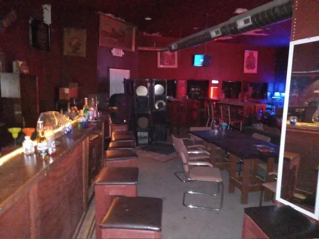 a kitchen with stainless steel appliances dining table and chairs