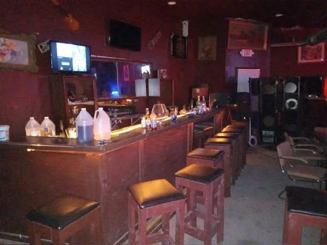 a dinning room with table chairs and wooden floors