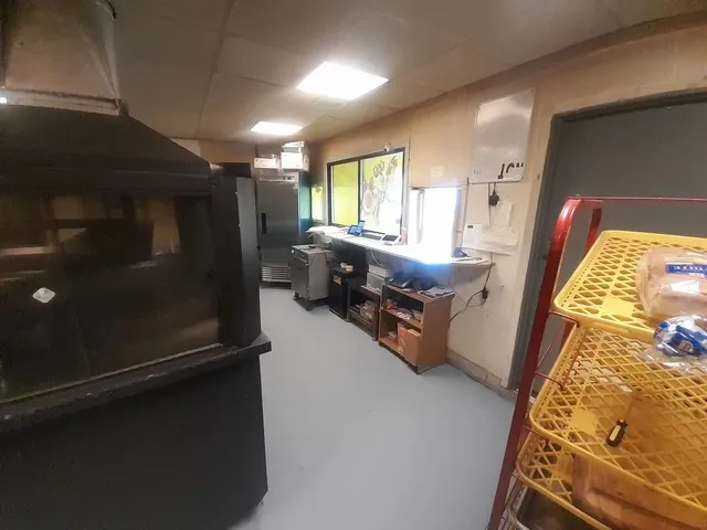 a kitchen with sink refrigerator and window