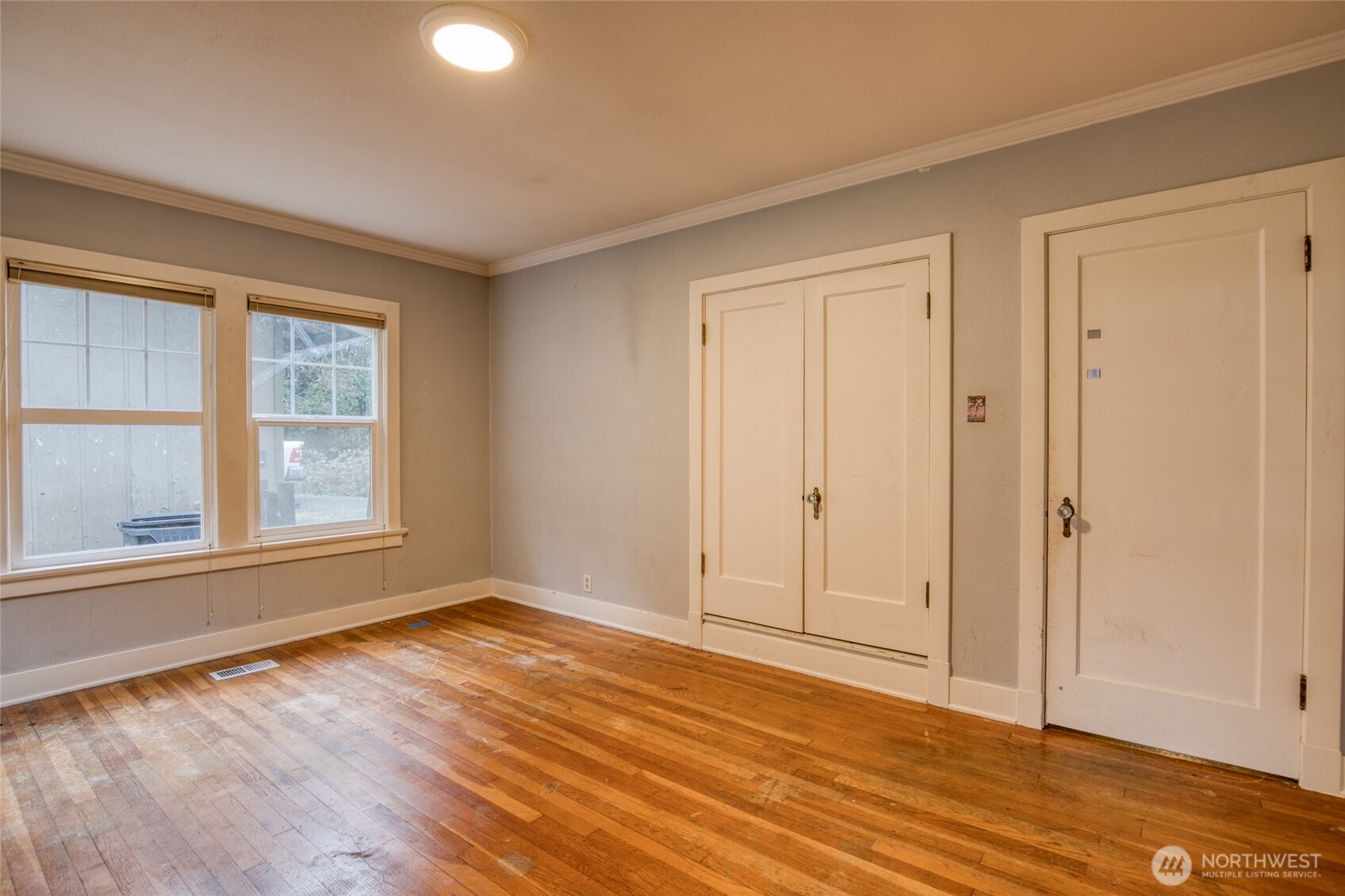 3321 Wishkah Road Aberdeen, WA 98520 - Photo 21 of 40 a view of an empty room with wooden floor and a window