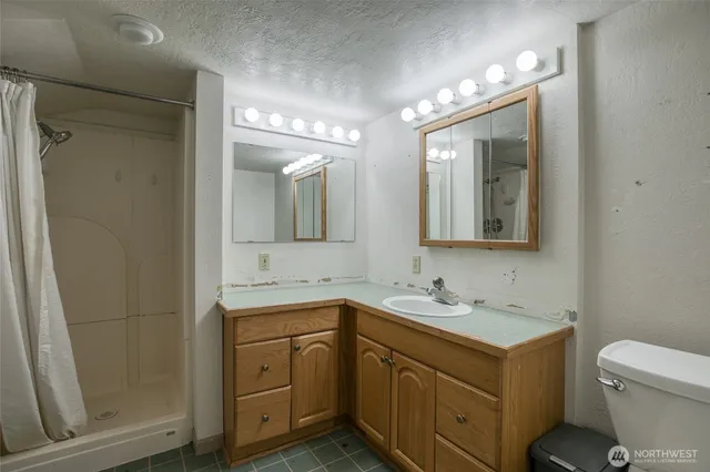 a bathroom with a toilet sink and mirror